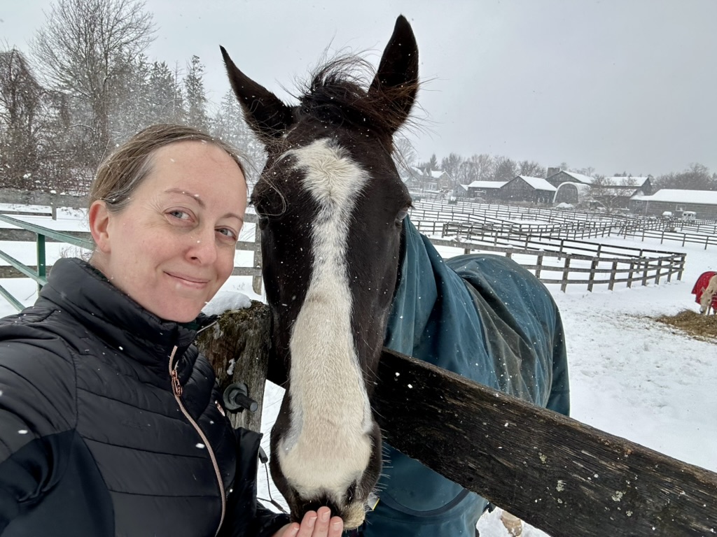 Jacklyn and her horse on a snowy day at the barn